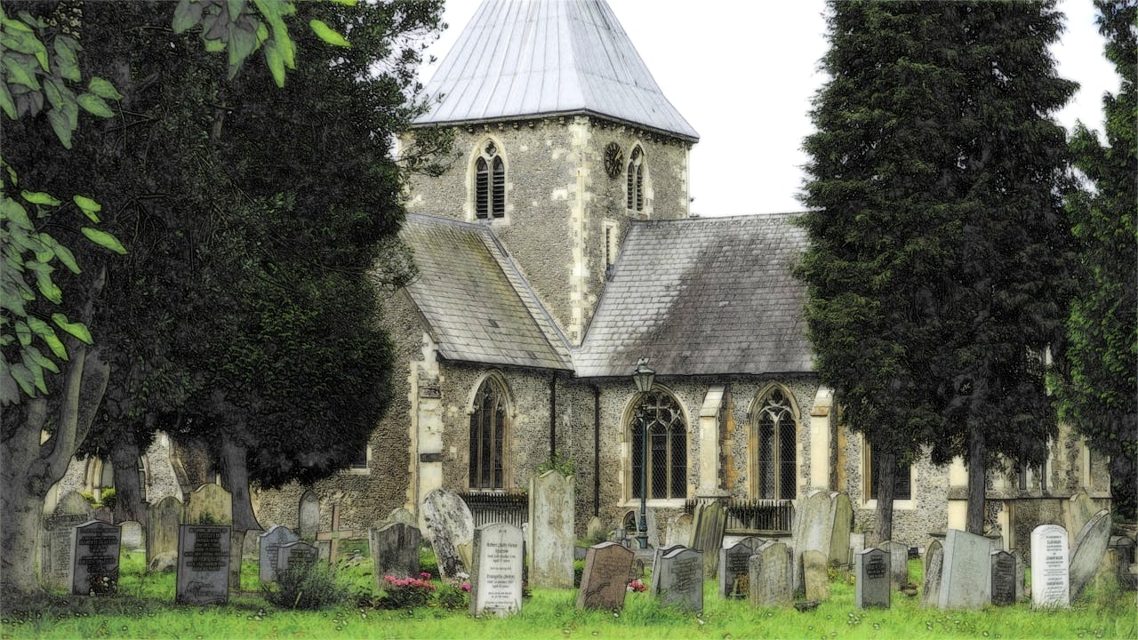 our-services-01 An old church surrounded by gravestones in a peaceful, green graveyard.